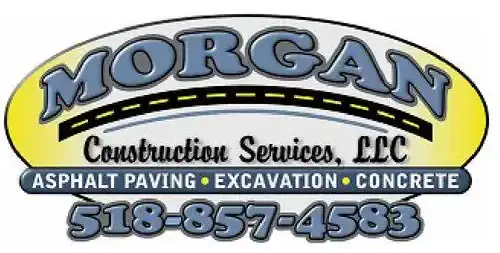 Logo for Morgan Construction Services, LLC. Includes text: "ASPHALT PAVING • EXCAVATION • CONCRETE" and phone number "518-857-4583." Background features a road graphic and yellow-to-gray gradient.
